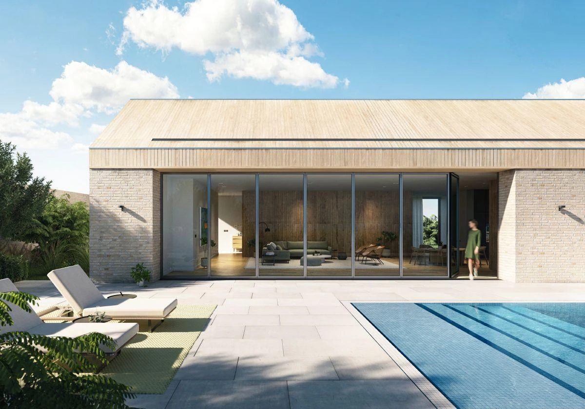 Wide Schüco bifold glass wall facing a pool terrace – aluminum bifold doors featured on Schüco Aluminum Bifold Doors USA | AS FD 75 & 90.HI