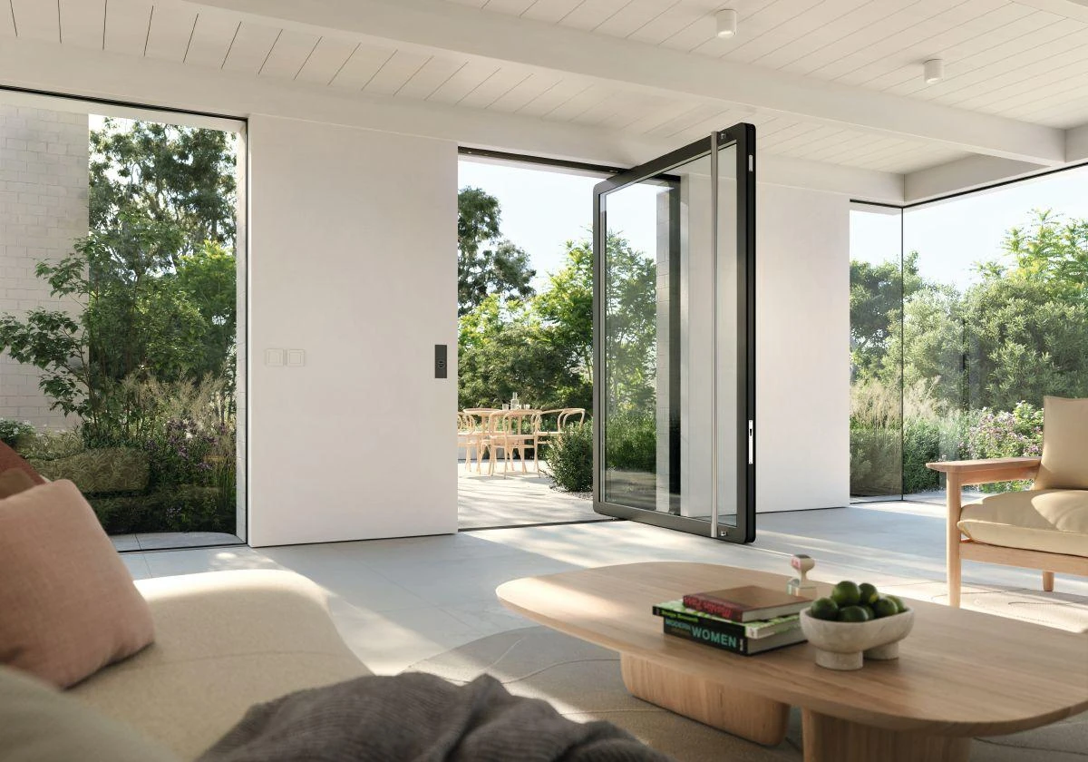 Large Schüco AD AL 75 aluminum pivot door open in a modern – custom aluminum doors featured on Schüco Aluminum Doors USA | AD UP, Pivot &