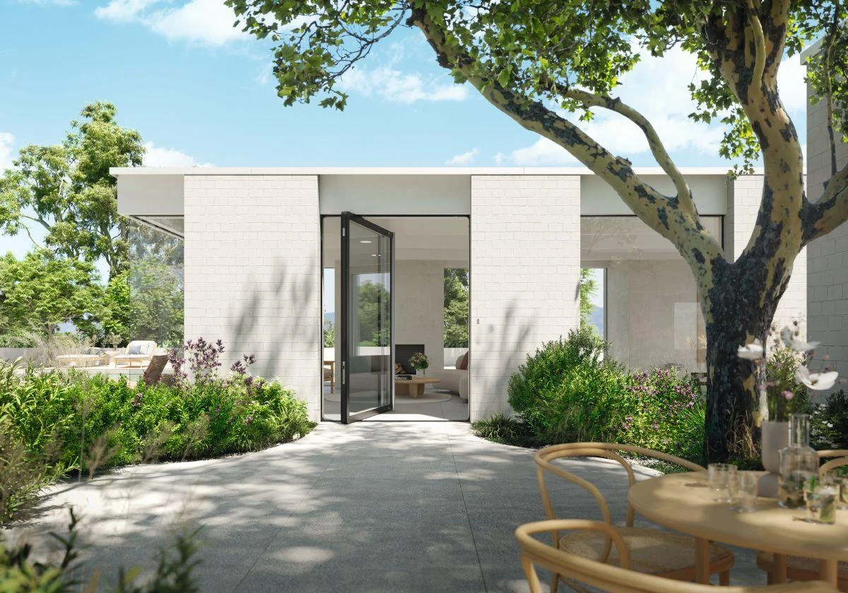 Open full-height glass aluminum pivot door facing a landscaped – custom aluminum doors featured on Schüco Aluminum Doors USA | AD UP, Pivot &