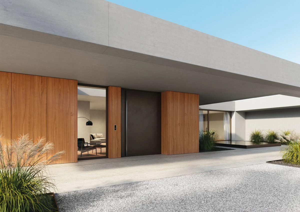 Large flush aluminum pivot entrance integrated into a modern – custom aluminum doors featured on Schüco Aluminum Doors USA | AD UP, Pivot &