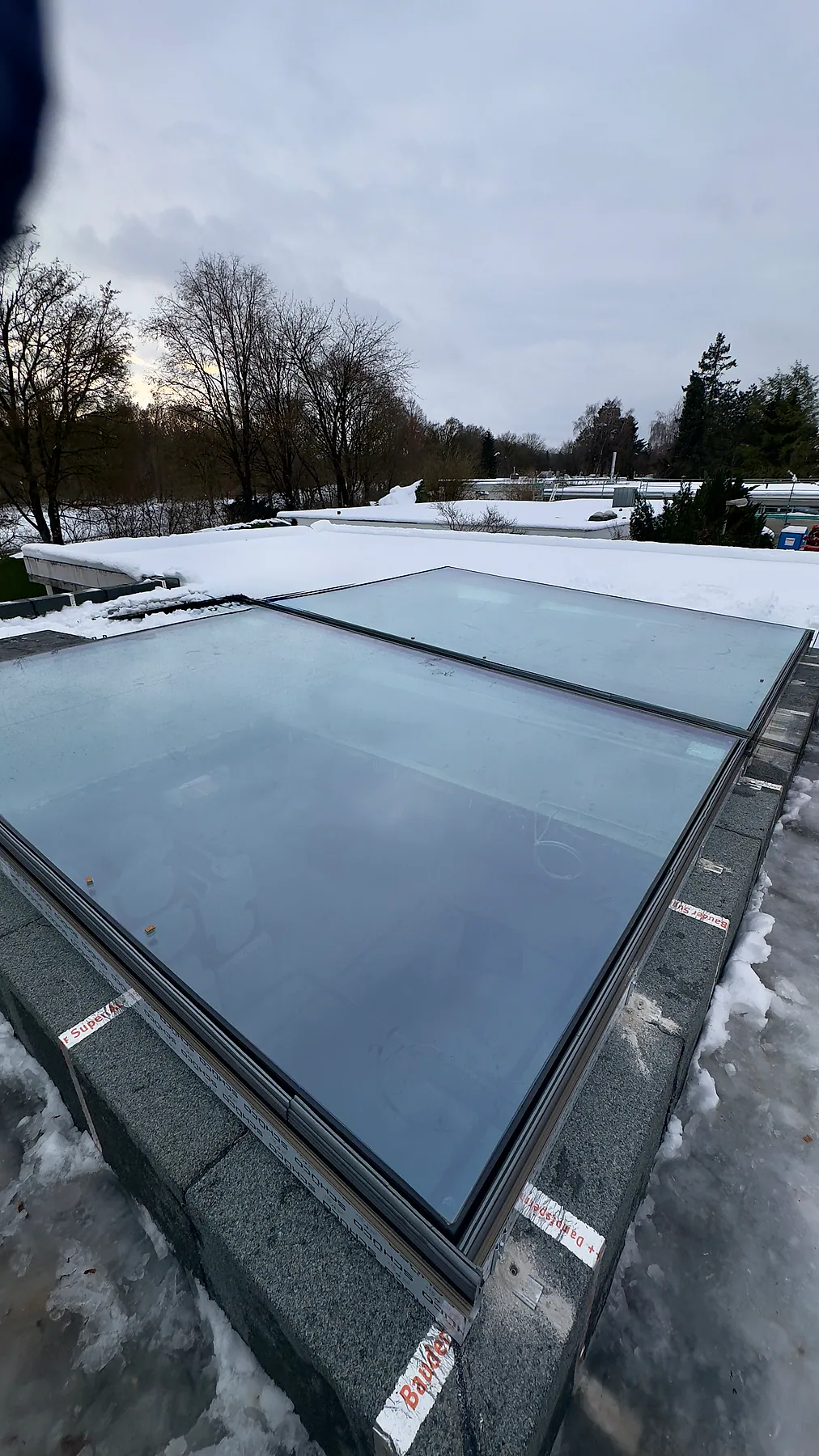 Flat roof aluminum skylight during installation – aluminum project reference featured on Projects & References | Custom Aluminum Windows