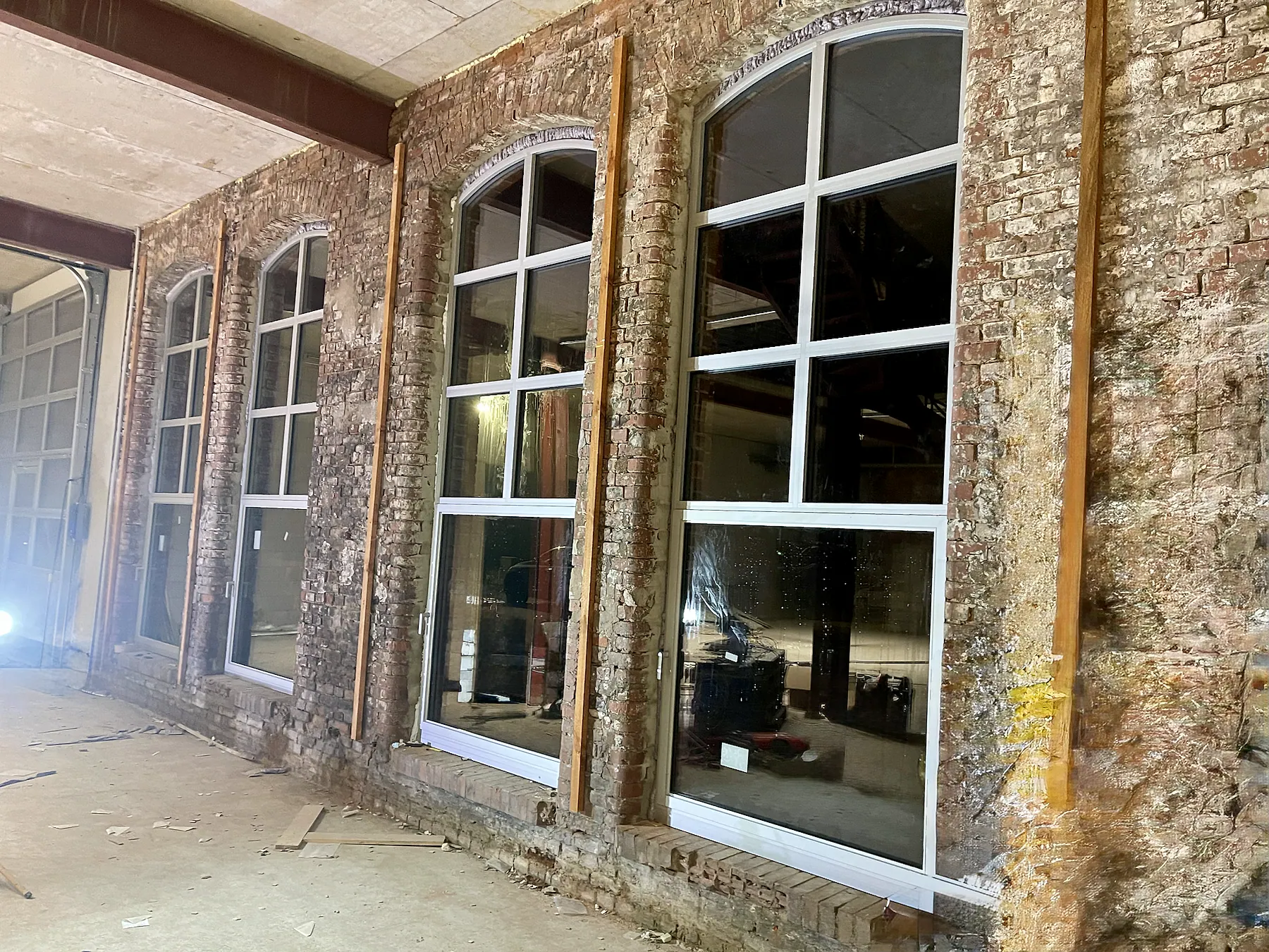 Historic industrial façade with new aluminum arched windows – aluminum project reference featured on Projects & References | Custom Aluminum Windows