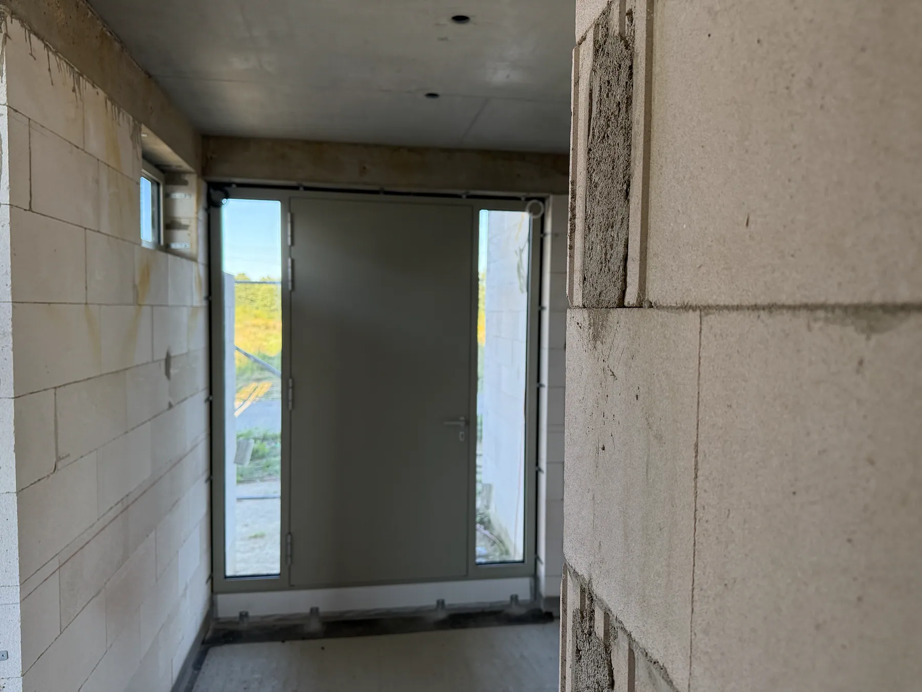 Custom aluminum entry door with glazed sidelights in a private – aluminum project reference featured on Projects & References | Custom Aluminum Windows